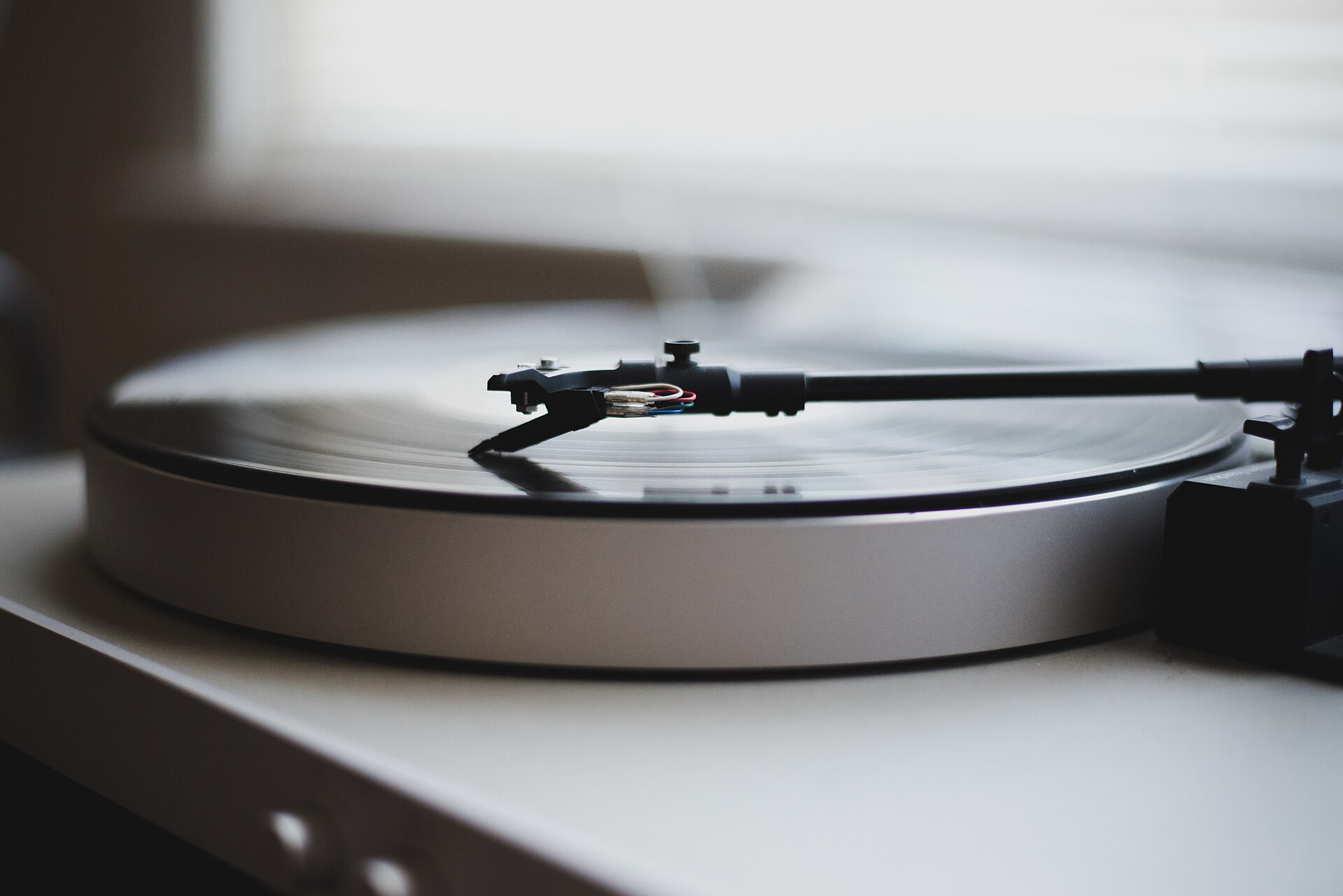 A turntable with the needle down, the cover of The Claude Academy