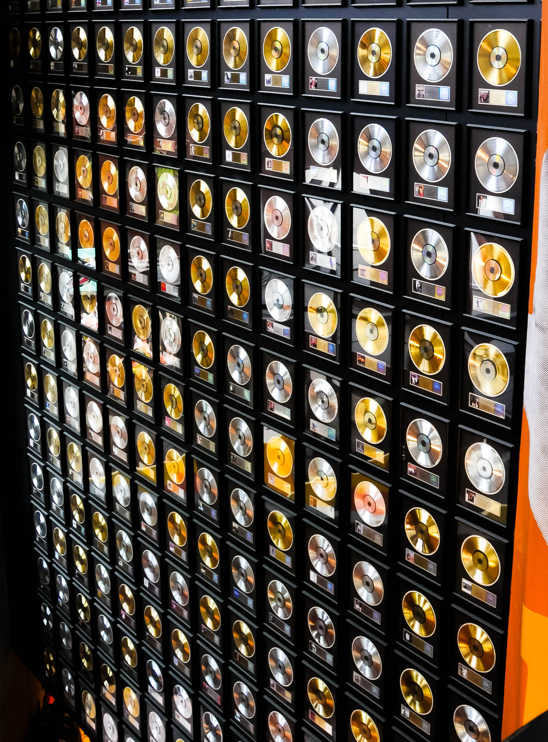 A museum wall of framed gold records, the cover of The Meta AI Academy