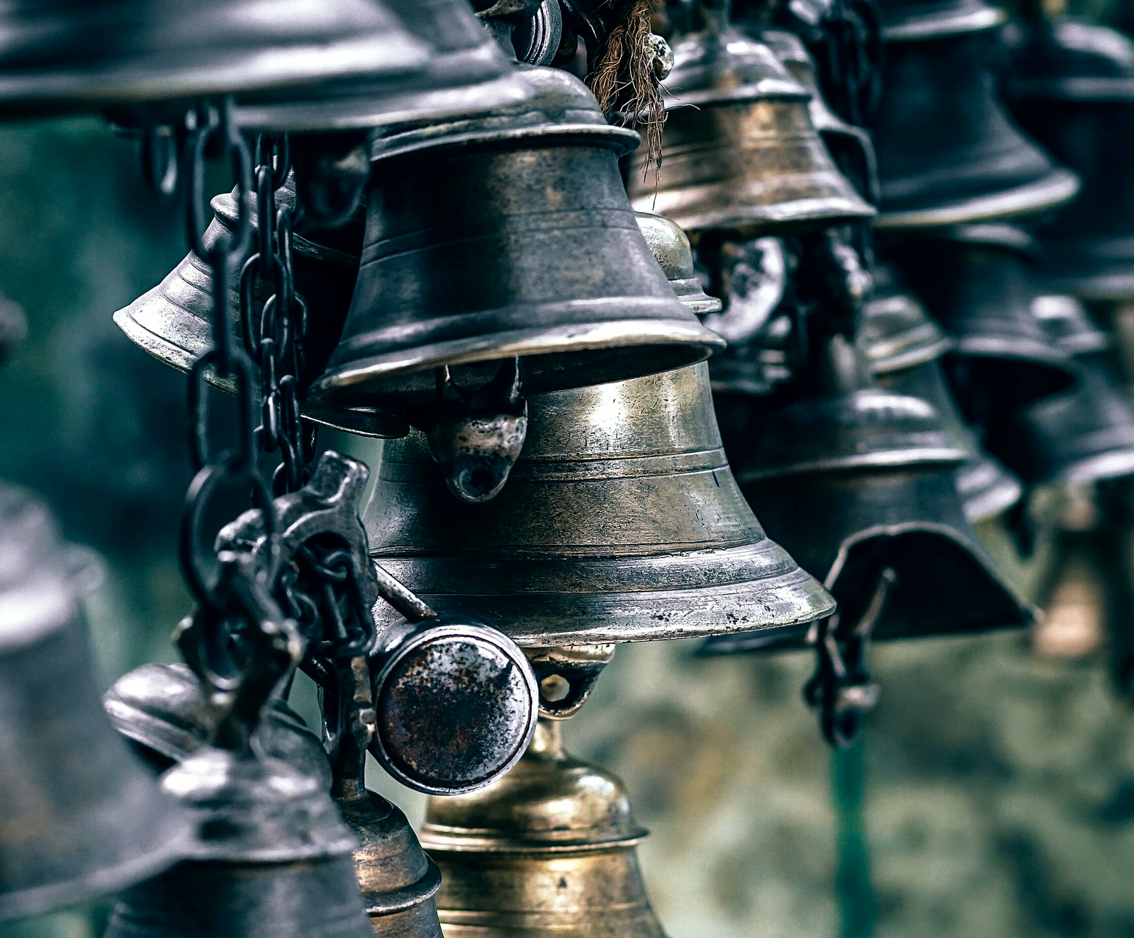 A wall of hanging brass bells, the cover of The Trading Desk